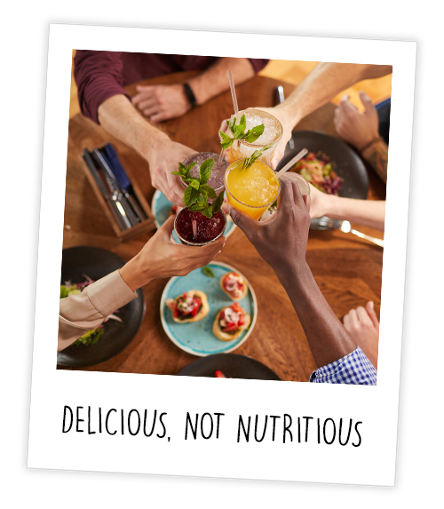 A Polaroid of people clinking drinks over brunch dishes