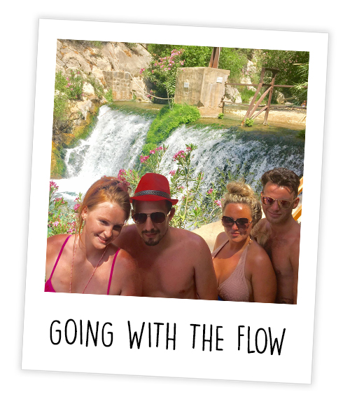 A Polaroid of two men and two women posing in front of the Algar Falls which is captioned Going With The Flow