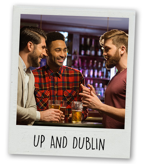 A Polaroid of three men drinking with the caption Up and Dublin