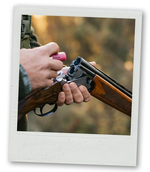 A Polaroid of a man loading a clay pigeon shooting gun