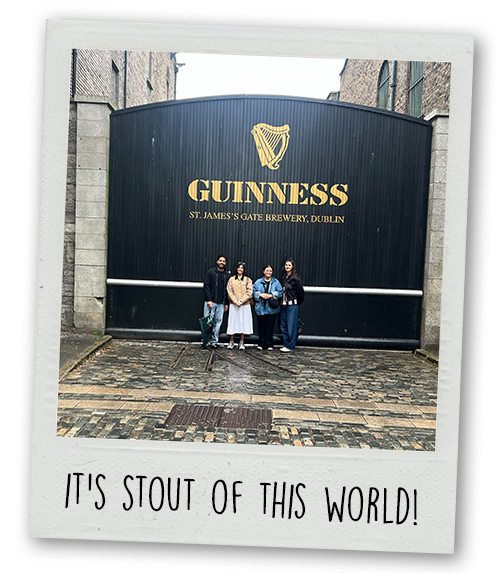 A Polaroid of some members of LNOF staff stood in front of a big black gate that reads Guinness St James' Gate Brewery Dublin