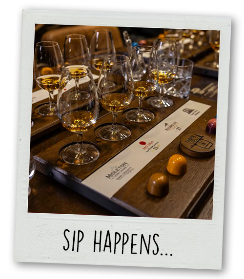 A Polaroid of a whiskey tasting with the caption Sip Happens