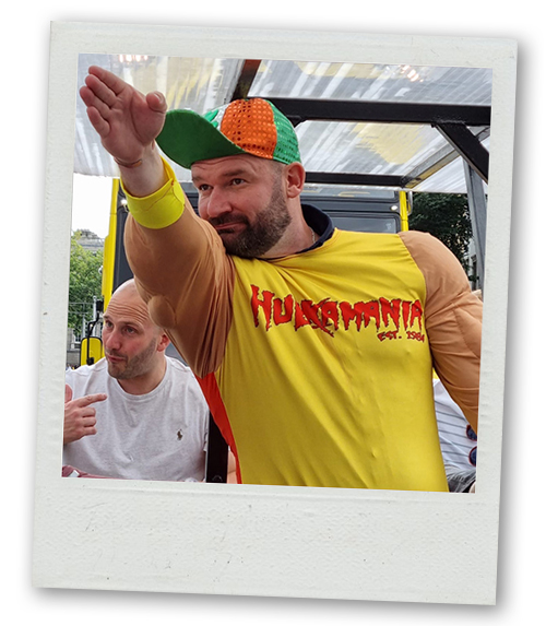 A Polaroid of a man on a pedi bus wearing fancy dress