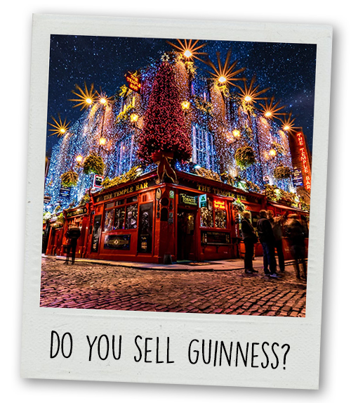 A Polaroid of Temple Bar lit up at night with the caption Do You Sell Guinness?