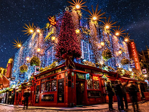 Temple Bar at night with lots of lights on it 