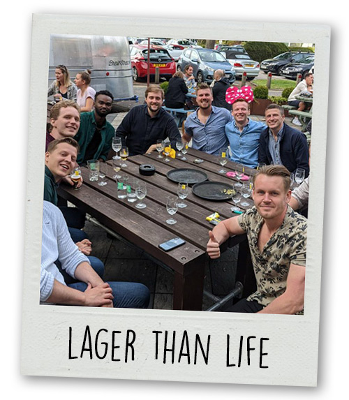 A Polaroid of a stag do group sitting outside a brewery with the caption Lager Than Life