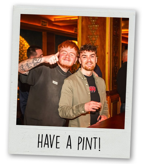 A Polaroid of two men drinking in Concert Square with the caption Have a Pint!