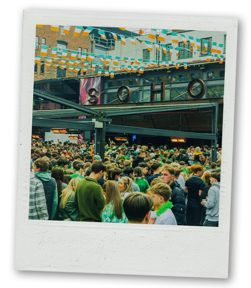 A Polaroid of lots of party goers clustered around Soho in the heart of Concert Square