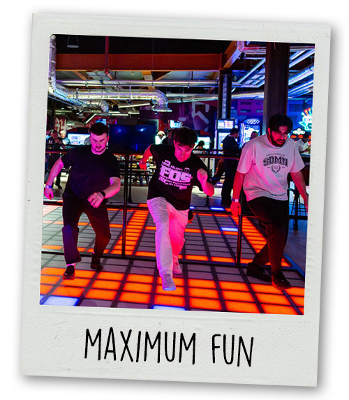 A Polaroid of three men at Gravity Max playing a game with a light up floor with the caption Maximum Fun