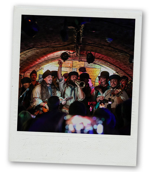 A Polaroid of bar on Mathew Street that has a large group of musicians performing for a crowd