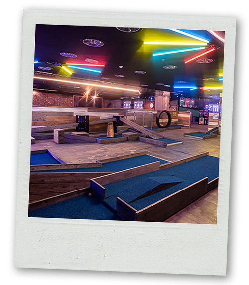 A Polaroid of a mini golf course that has ramps and loops
