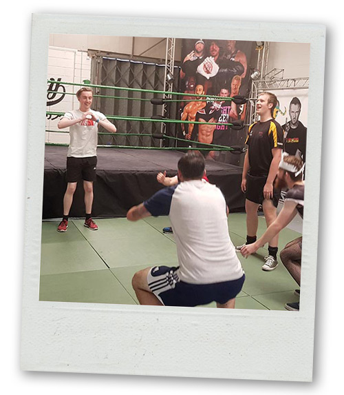 A Polaroid of a stag group learning some wrestling moves