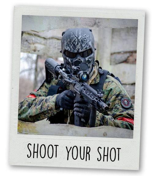 A Polaroid of a man doing paintball with the caption Shoot Your Shot