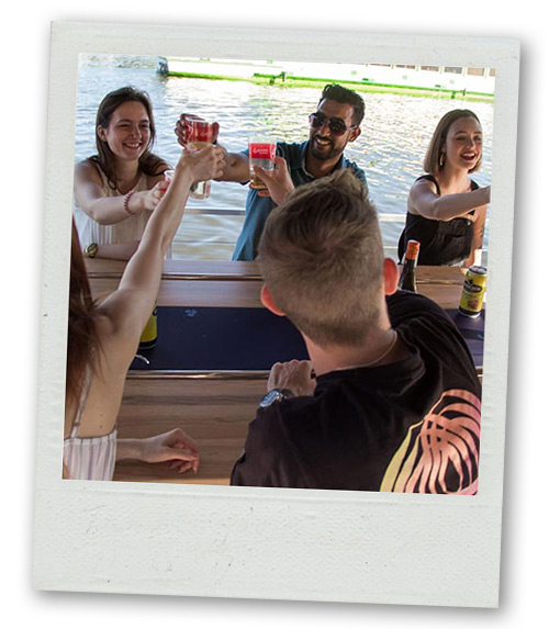 A Polaroid of mixed gender group of people having a drink on the beer pedal boat