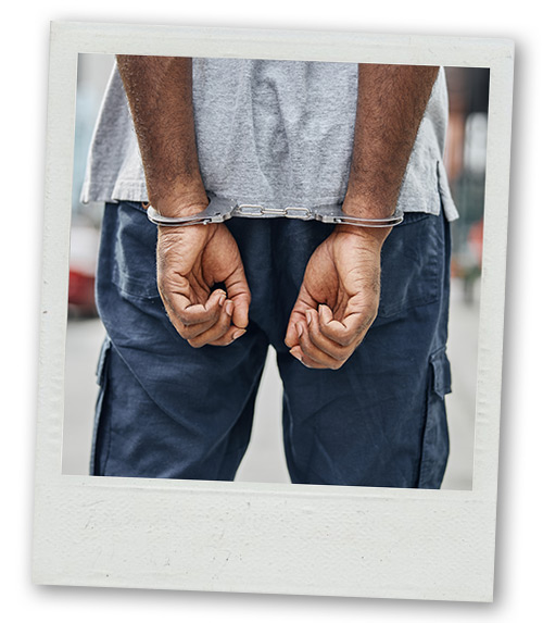 A Polaroid of a stag with his hands behind his back in handcuffs as part of a prank