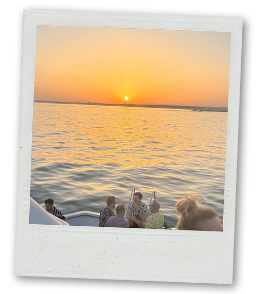 A Polaroid of a view from a boat as the sun is about to set