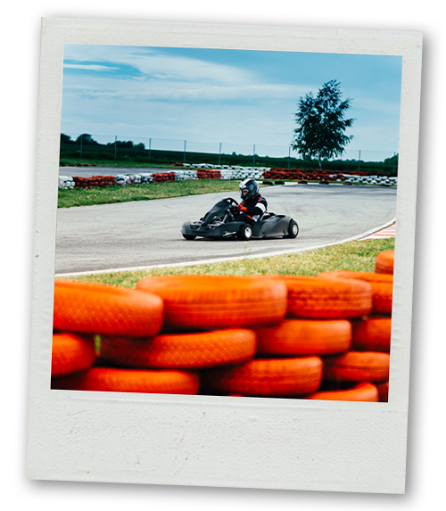 A Polaroid of a man go karting