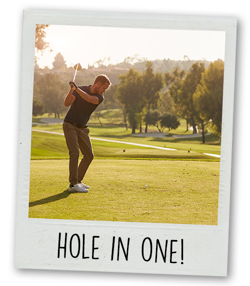 A Polaroid of a man taking a big swing at a golf ball with the caption Hole in One!