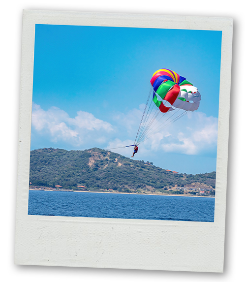 A Polaroid of a man parasailing