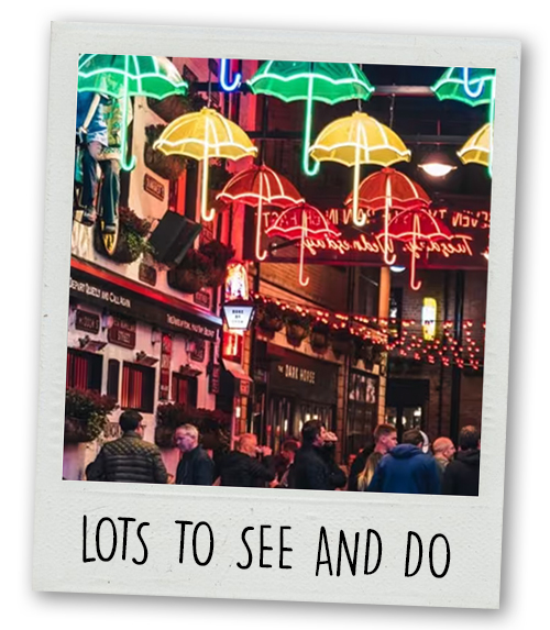 A Polaroid of a street in the Cathedral Quarter that has an umbrella themed art instillation