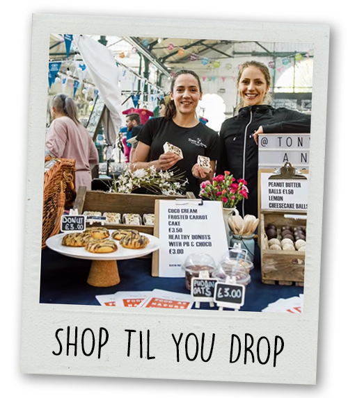A Polaroid of a market stall in St George's Market with the caption Shop Til You Drop