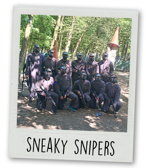 A Polaroid of a stag do group posing in their airsoft gear in a forest with the caption Sneaky Snipers