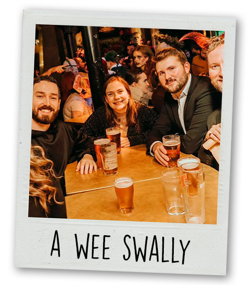 A Polaroid of a mixed gender group having a drink with the caption A Wee Swally