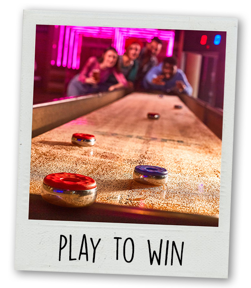 A Polaroid of a shuffleboard table with the caption Play To Win