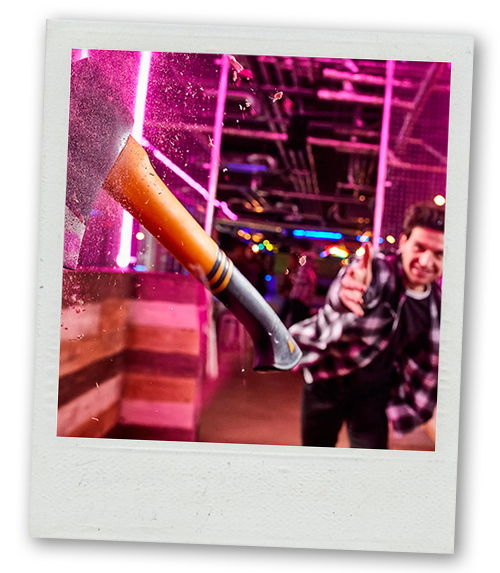 A Polaroid of a man throwing an axe at a target