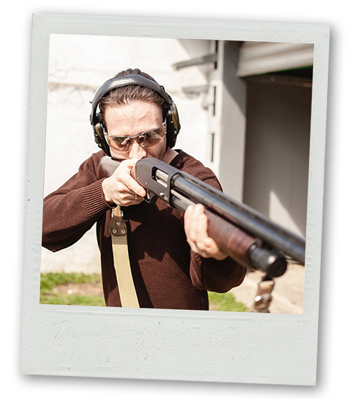 A Polaroid of a man aiming a clay pigeon shooting gun