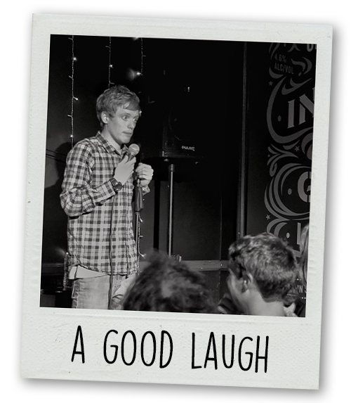 A Polaroid of a man doing stand up comedy which is captioned with A Good Laugh 
