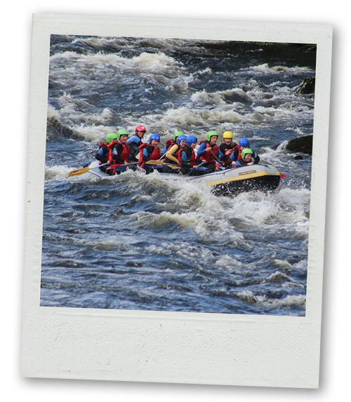 A Polaroid of a group of men going over a rapid