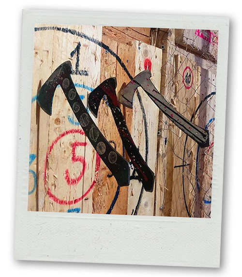 A Polaroid of three axes sticking out of a target