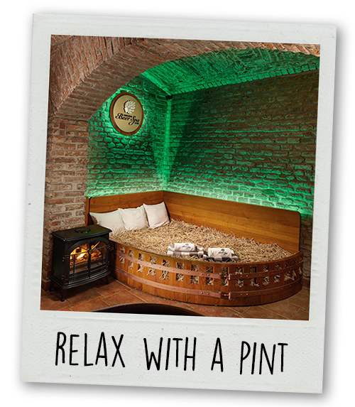 A Polaroid of a straw bed in a spa with the caption Relax with a Pint