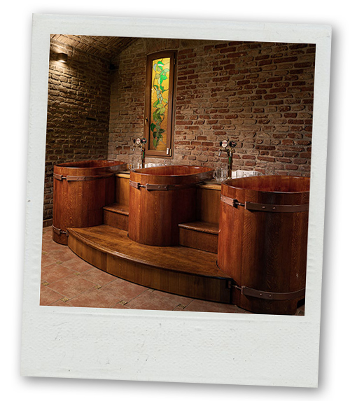 A Polaroid of three wooden barrels that you can relax in