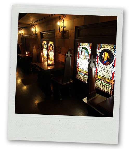 A Polaroid of a medieval themed restaurant with stained glass windows