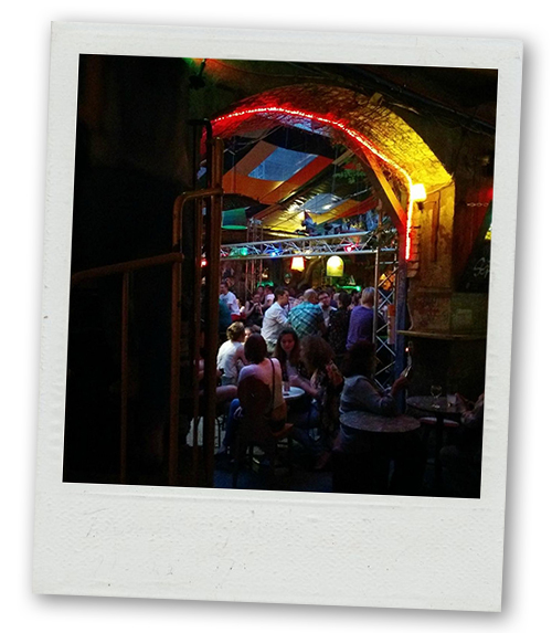 A Polaroid of people inside a ruin bar