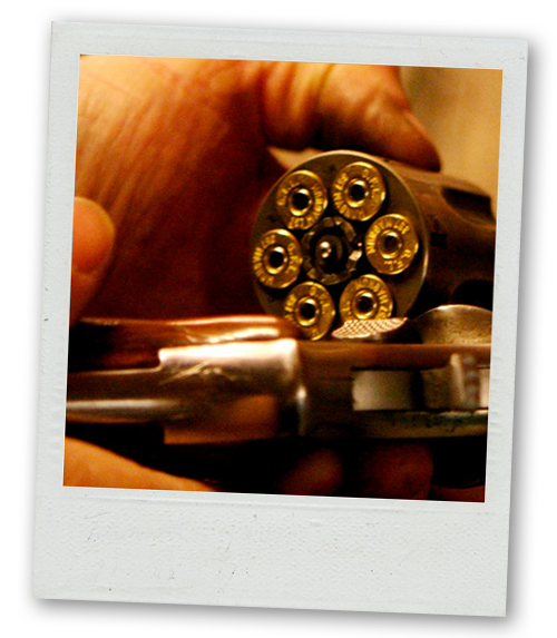 A Polaroid of someone loading a gun