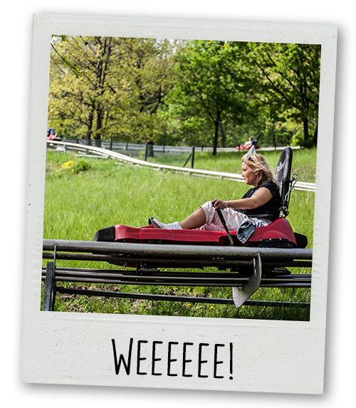 A Polaroid of a woman doing a toboggan run with the caption weeeee