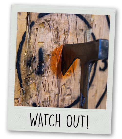A Polaroid of an axe sticking in a target with the caption Watch Out