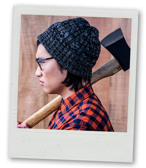 A Polaroid of a person in a flannel top holding an axe