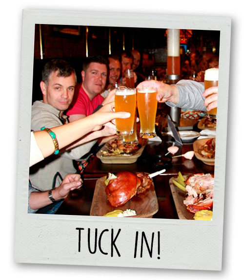 A Polaroid of a group of lads clinking pints over a brewery dinner with the caption Tuck In