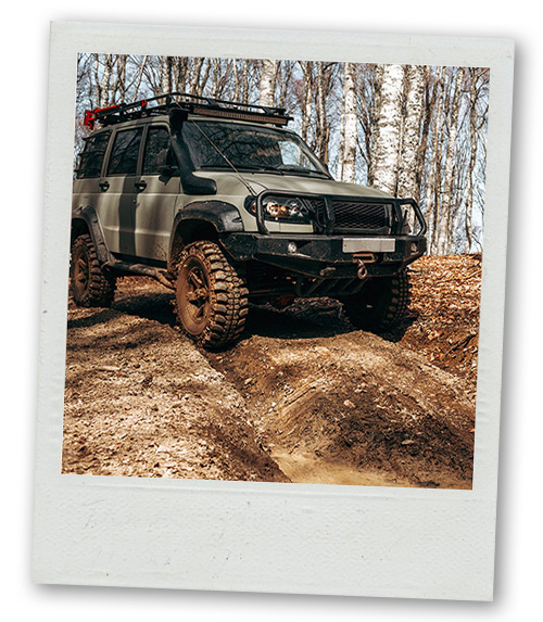 A Polaroid of an off road vehicle going over a small bump