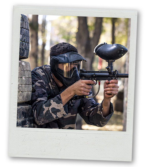 A Polaroid of a man pointing a paintball gun