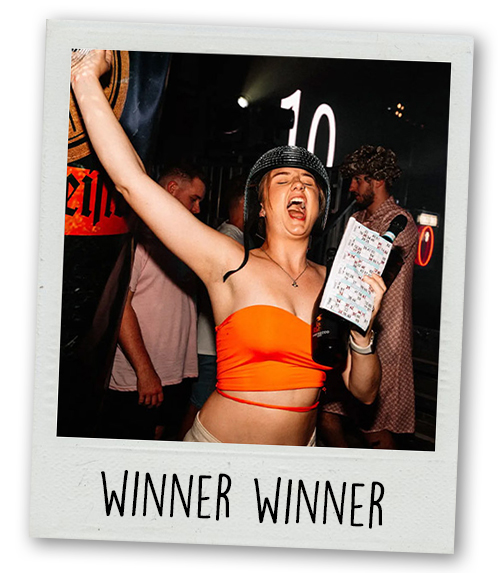 A Polaroid of a woman holding a bingo sheet and a bottle of drink with the caption Winner Winner