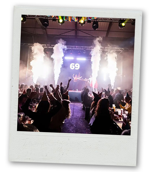 A Polaroid of people up on a stage with smoke shooting from the stag and the number 69 displayed