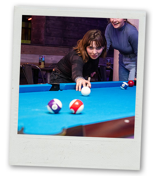 A Polaroid of a woman playing pool