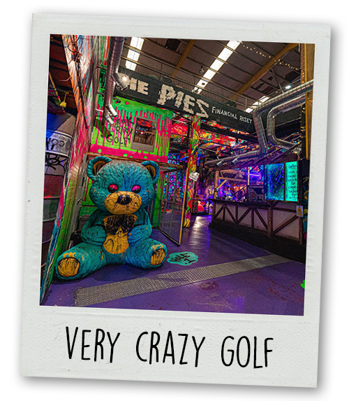 A Polaroid of Big Fang crazy golf which has a big blue teddy bear statue with the caption Very Crazy Golf
