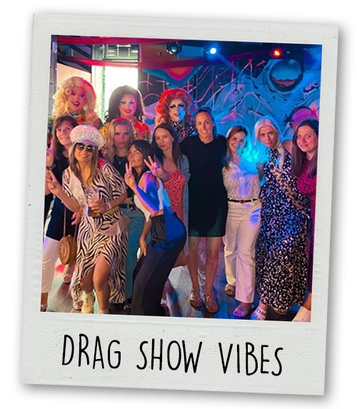 A Polaroid of a hen do group posing with several drag queens with the caption Drag Show Vibes