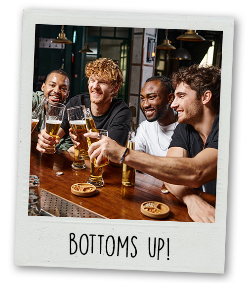 A Polaroid of a stag do group drinking at a bar with the caption bottoms up